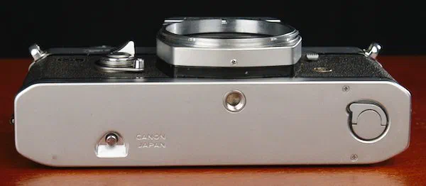 Bottom plate of the Canon 35mm camera with the film rewind lock and film door switch Bottom plate of the Canon 35mm camera with the film rewind lock and film door switch