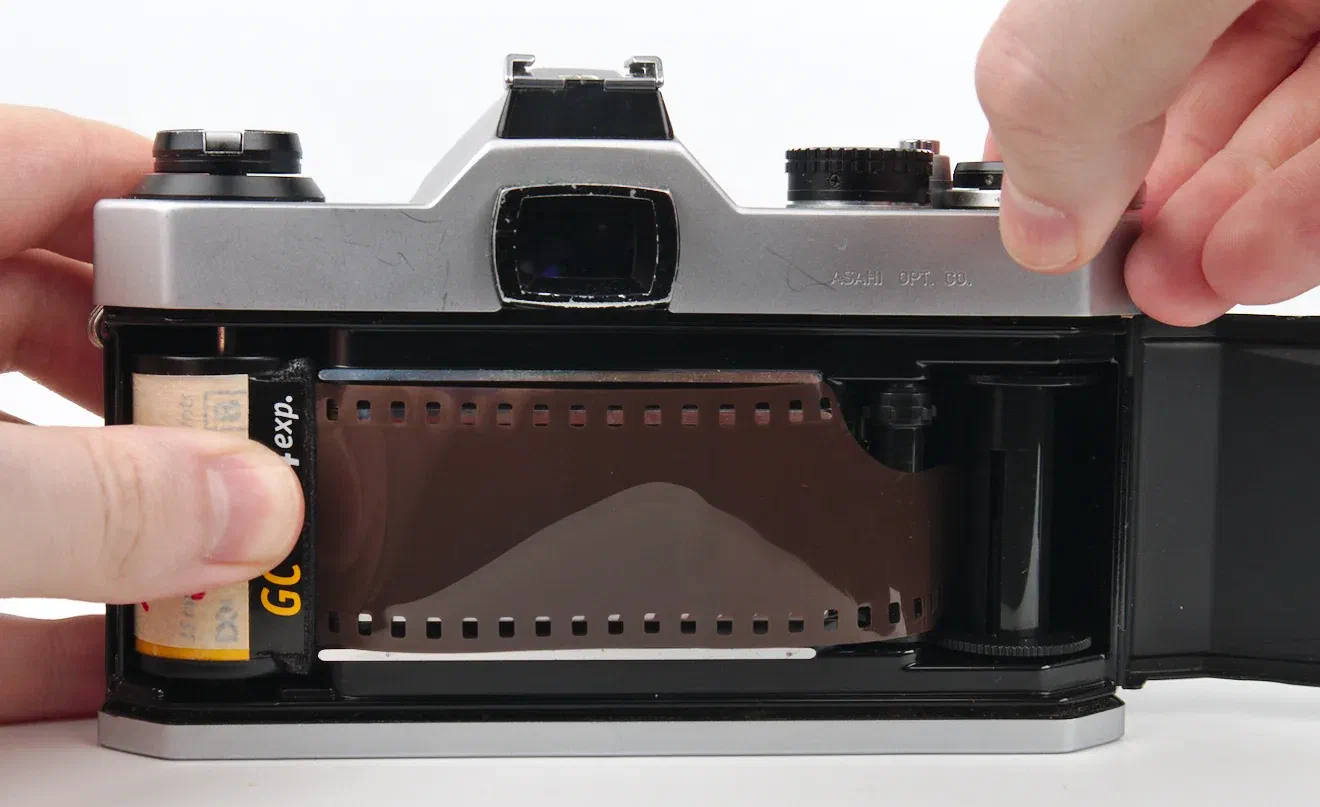 Hold Film Canister and Advance the Film Hold Film Canister and Advance the Film